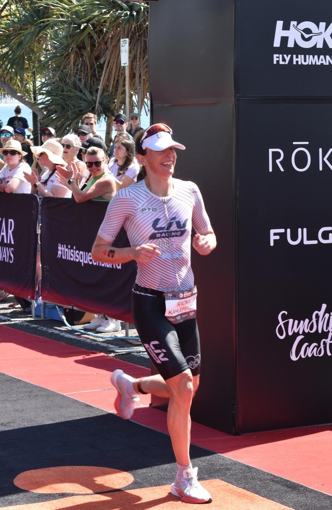 Women's second place: Radka Kahlefeldt crossing the finish line at Sunshine Coast Ironman 70.3 2023.