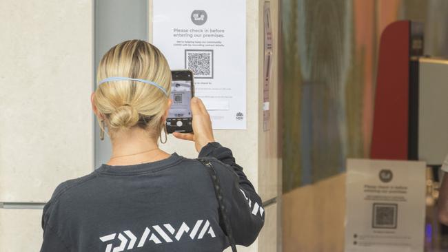 A shopper uses a QR code at a supermarket at The Corso in Manly. (Photo by Jenny Evans/Getty Images)