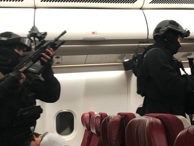 Police enter the plane. Picture: Andrew Leoncelli