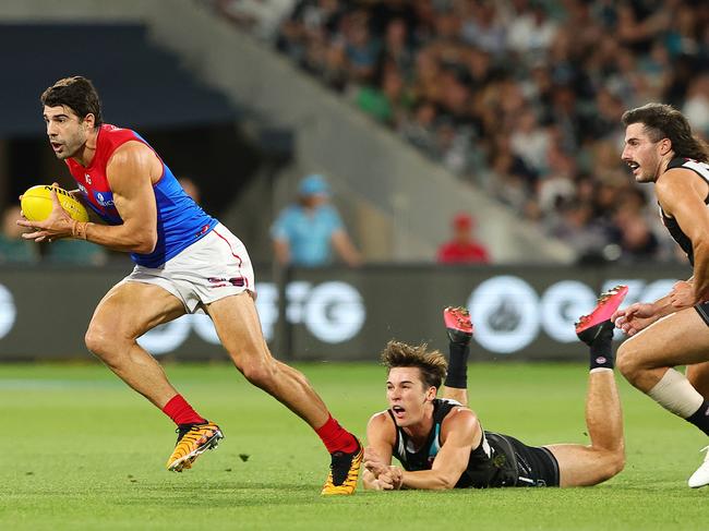 Christian Petracca gets away from Connor Rozee. Picture: Sarah Reed/AFL Photos