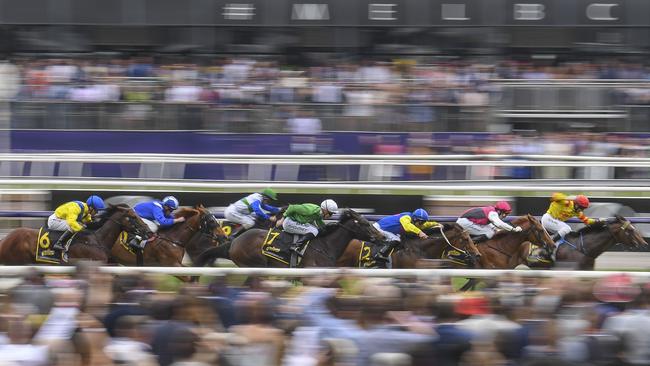 Runners make their way down the home straight on the Melbourne Cup Day support card at Flemington. Picture Jay Town