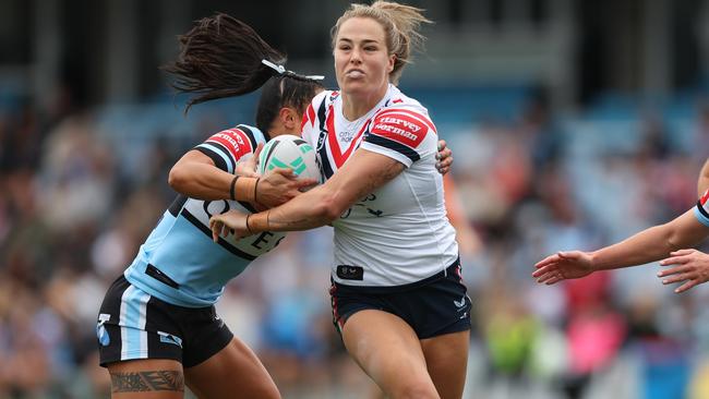 SYDNEY, AUSTRALIA - SEPTEMBER 08: Isabelle Kelly of the Roosters is tackled during the round seven NRLW match between Cronulla Sharks and Sydney Roosters at PointsBet Stadium on September 08, 2024 in Sydney, Australia. (Photo by Mark Metcalfe/Getty Images)