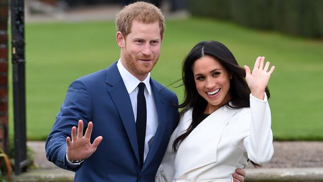 Prince Harry and Meghan Markle pose for the media in the grounds of Kensington Palace this morning.