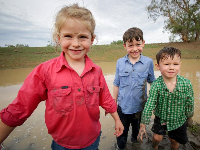 Wet, muddy and as happy as can be: Edith, Digby and Duguld play in the dam on their parents’ property at Warialda. Picture: Liam Driver