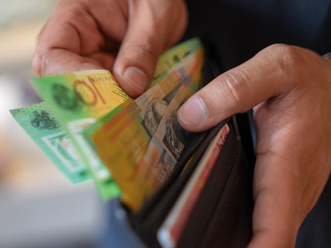 a male taking money out of the valet.