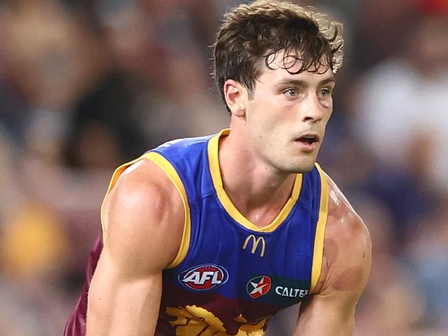 BRISBANE, AUSTRALIA - MARCH 24: Josh Dunkley of the Lions handballs during the round two AFL match between Brisbane Lions and Melbourne Demons at The Gabba, on March 24, 2023, in Brisbane, Australia. (Photo by Chris Hyde/Getty Images)