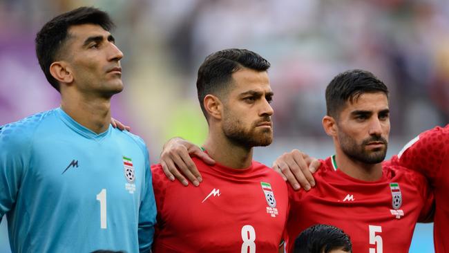 Iran players (from left) Alireza Beiranvand, Morteza Pouraliganji and Morteza Pouraliganji line up for the national anthem before their World Cup opener. Picture: Matthias Hangst/Getty Images