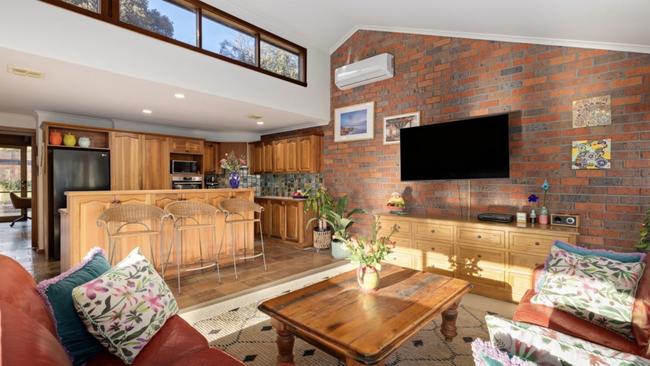 The spacious open-plan living area with high-pitched ceilings and skylights.