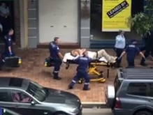 Det Sgt Breda is taken to an ambulance after he was stabbed the Maroubra Junction Hotel in Sydney in 2018.