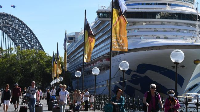 Cruise ship passengers disembark the Ruby Princess cruise ship at Sydney’s Circular Quay. More than 60 of its Queensland passengers have developed the novel coronavirus after leaving the boat. Photo: Dean Lewins/AAP