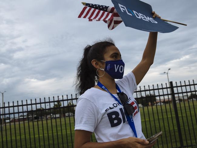 A Biden supporter holds a flag. Picture: Angus Mordant for NewsCorp Australia