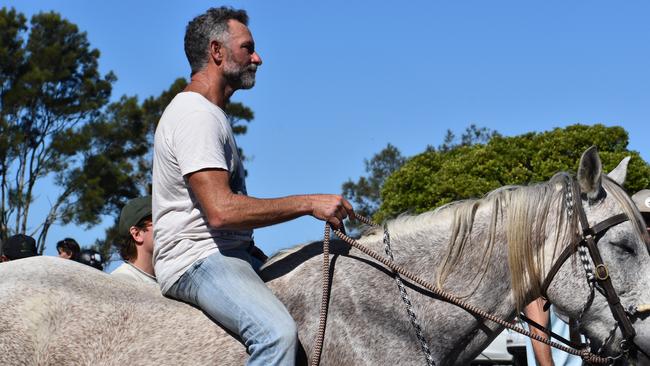 A man riding a horse was heard to encourage protesters to cross the border. Photo: Liana Walker