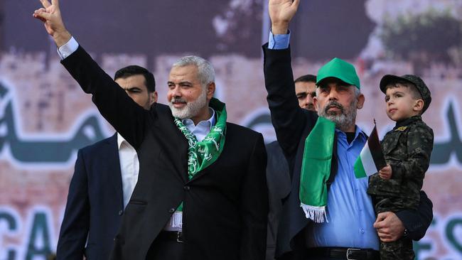 Then Hamas leader Ismail Haniya (L) with Yahya Sinwar at a rally marking the 30th anniversary of the founding of Hamas. Picture: AFP.