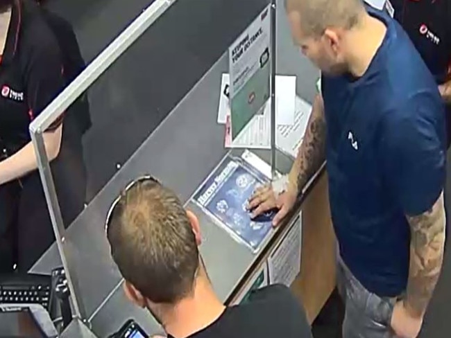 CCTV images of Robert Atkins (in blue) at BankSA, standing alongside one of the men who were forcing him to commit fraud the day before his death. Picture: Dean Martin