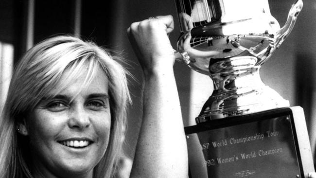 Wendy Botha shows off one of her four world championship trophies at Sydney Airport.