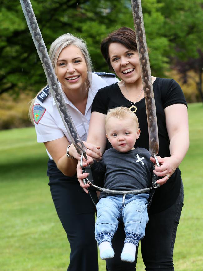 Kristy Monson with her son Jack (now 16 months) and Ambulance Tasmania’s Philippa Behrens are united at Burnie in the state’s North after an emergency 000 call saved Jack’s life. Picture: CHRIS KIDD.