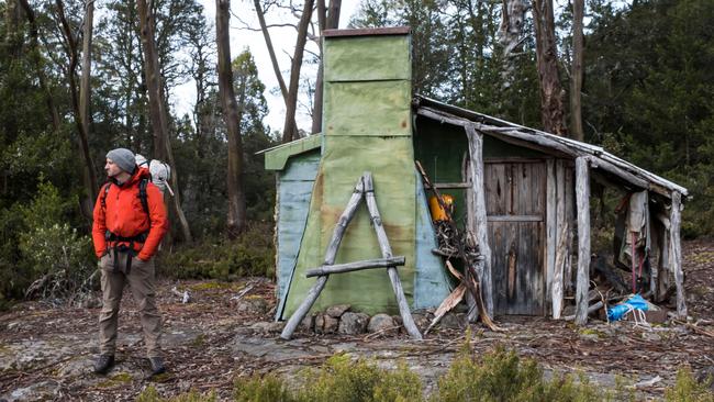 Walker and trout fisherman Richard Webb outside the historic hut on Halls Island on Lake Malbena in the Walls of Jerusalem National Park and Tasmania’s World Heritage Area. Picture: CHRIS CRERAR