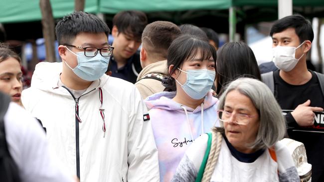 People wearing masks in Brisbane City yesterday. Picture: Steve Pohlner