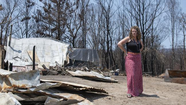 Ms Jongen standing next to the remains of the home she had lived in since she was one year old.