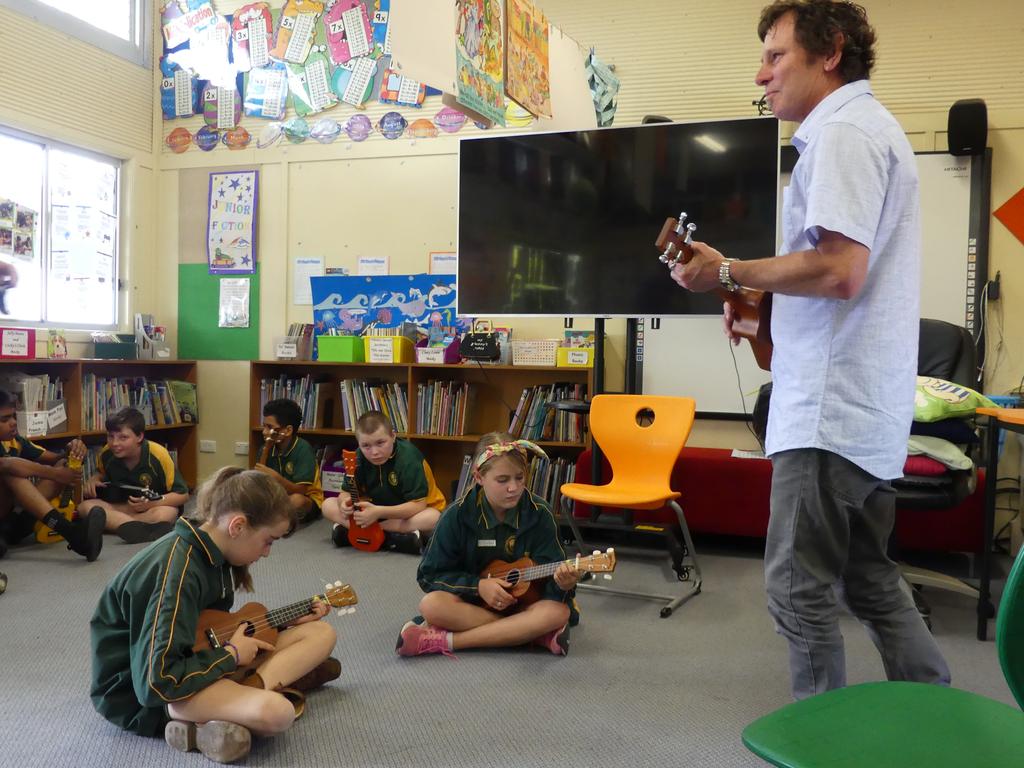 Topology's Matt Wild jamming with Moffatdale State School students on the ukulele. Photo/Holly Cormack.