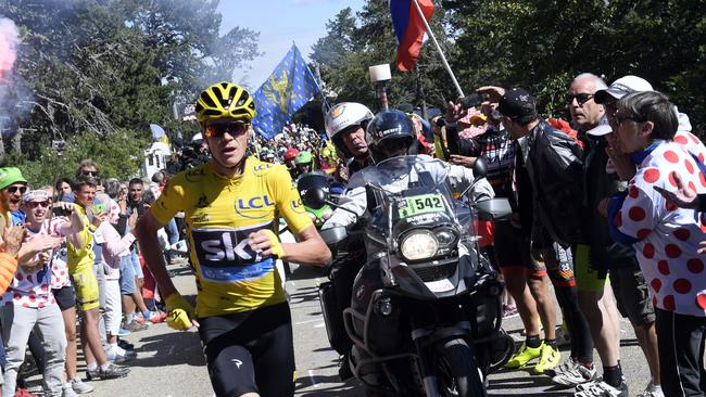 Britain's Chris Froome, wearing the overall leader's yellow jersey runs after he crashed near the end of the twelfth stage of the Tour de France.