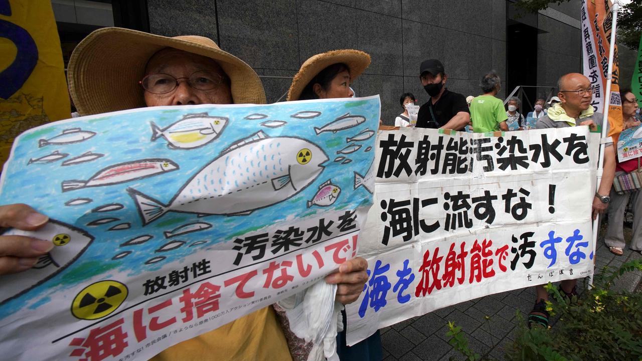 Protesters outside the TEPCO headquarters in Tokyo held signs reading: “don't throw radioactive contaminated water into the sea!” and “don't pollute the sea with radioactivity” at a rally on August 24. Picture: Kazuhiro Nogi / AFP.