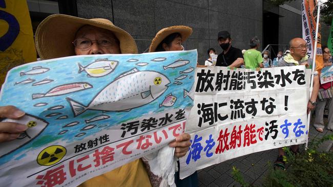 Protesters outside the TEPCO headquarters in Tokyo held signs reading: “don't throw radioactive contaminated water into the sea!” and “don't pollute the sea with radioactivity” at a rally on August 24. Picture: Kazuhiro Nogi / AFP.