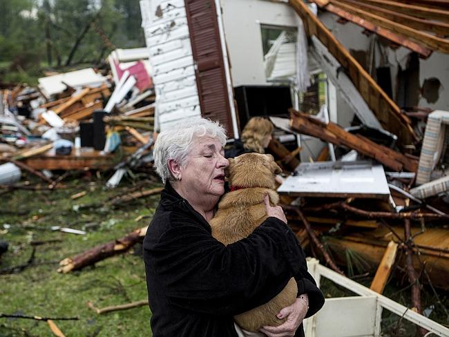 Heartbreak ... Constance Lambert embraces her dog after finding it alive when returning to her destroyed home in Tupelo. AP Photo/The Commercial Appeal, Brad Vest