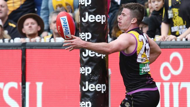 Jack Higgins passes the ball around the goal post. Picture: Michael Klein