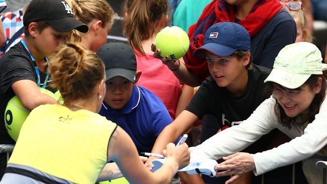 Svetlana Kuznetsova signs autographs for fans after winning her third round match against Jelena Jankovic. Picture: Getty Images