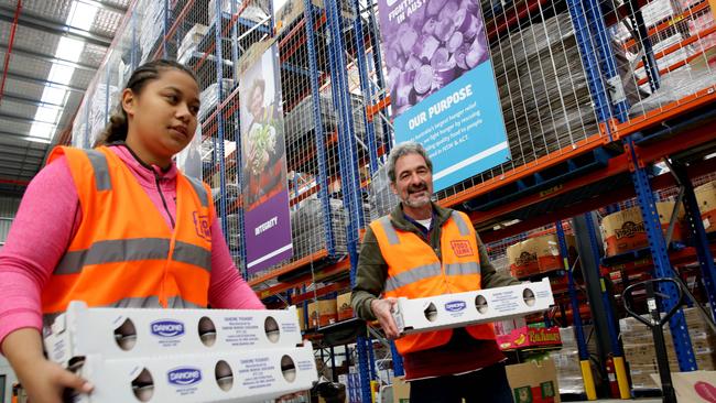 Foodbank warehouse, Glendenning, volunteers Luhama Palu and Bruce Riddell.