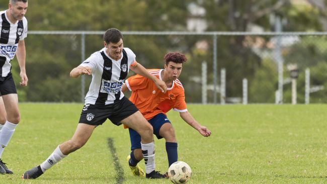 Willowburn captain Beau Partridge (left) and Hawks Saher Khidir battle for possession.