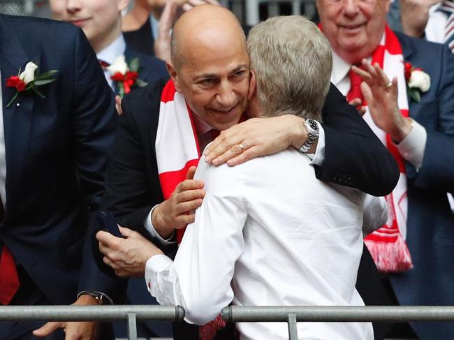 Arsenal's French manager Arsene Wenger (centre right) embraces chief executive Ivan Gazidis after their win over Chelsea in the English FA Cup final football match between Arsenal and Chelsea at Wembley stadium in London on May 27, 2017. Aaron Ramsey scored a 79th-minute header to earn Arsenal a stunning 2-1 win over Double-chasing Chelsea on Saturday and deliver embattled manager Arsene Wenger a record seventh FA Cup. / AFP PHOTO / Adrian DENNIS / NOT FOR MARKETING OR ADVERTISING USE / RESTRICTED TO EDITORIAL USE