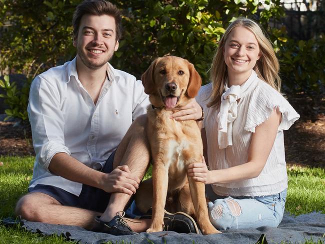 Jack Batty and Charlotte Thomas pose for a picture with their six month old dog Trooper in Eastwood, Sunday, Aug. 13, 2017. (AAP Image/MATT LOXTON)