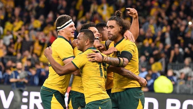 Kurtley Beale of the Wallabies (centre) celebrates with team mates after scoring a try during the Bledisloe Cup match between the Australian Wallabies and the New Zealand All Blacks at Optus Stadium in Perth, Saturday, August 10, 2019.  (AAP Image/Dave Hunt) NO ARCHIVING, EDITORIAL USE ONLY