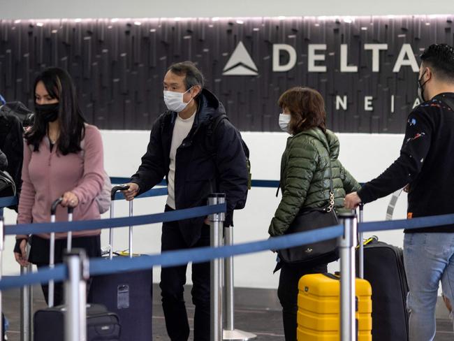 Travellers wait in line at Delta Airlines check-in at Los Angeles International Airport in Los Angeles, California, as thousands of flights are delayed around the world. Picture: AFP