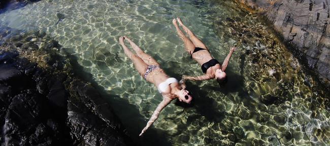 Hanna Gaida from Austria and Sabine Hartweck from Germany floating in paradise at the rockpools in Noosa National Park. Photo: Lachie Millard.