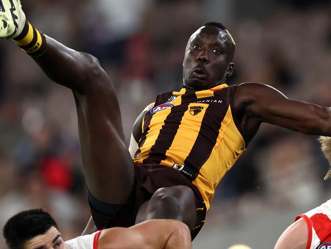 MELBOURNE, AUSTRALIA - APRIL 28: Mabior Chol of the Hawks flies for a mark over Lewis Melican of the Swans during the round seven AFL match between Hawthorn Hawks and Sydney Swans at Melbourne Cricket Ground, on April 28, 2024, in Melbourne, Australia. (Photo by Quinn Rooney/Getty Images)