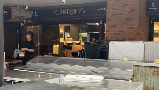 Staff at Charlie’s Restaurant Cafe and Bar in Surfers Paradise moving furniture in the business on Thursday afternoon.