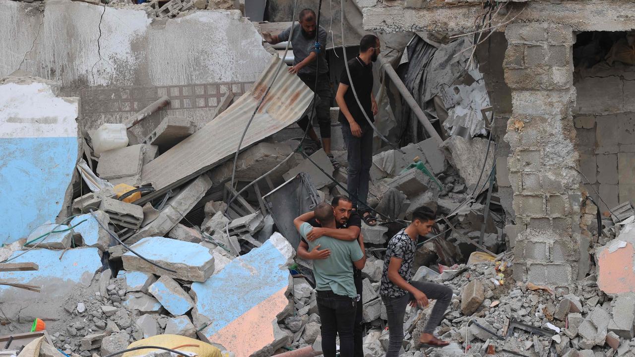 Palestinians look for survivors under the rubble of a house destroyed by an Israeli air strike in Rafah in the southern Gaza Strip. Picture: AFP