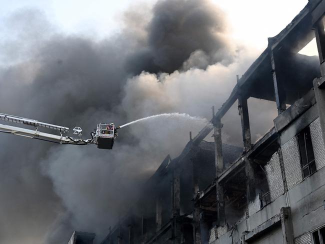 A firefighter extinguishes a fire at a civilian plant following Russian powerful attacks on the Ukrainian city of Kharkiv early on June 7. Picture: AFP