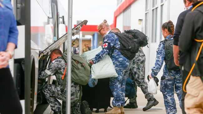 Australian Defence Force personnel packing their luggage into a bus at Burnie Airport. Picture: PATRICK GEE