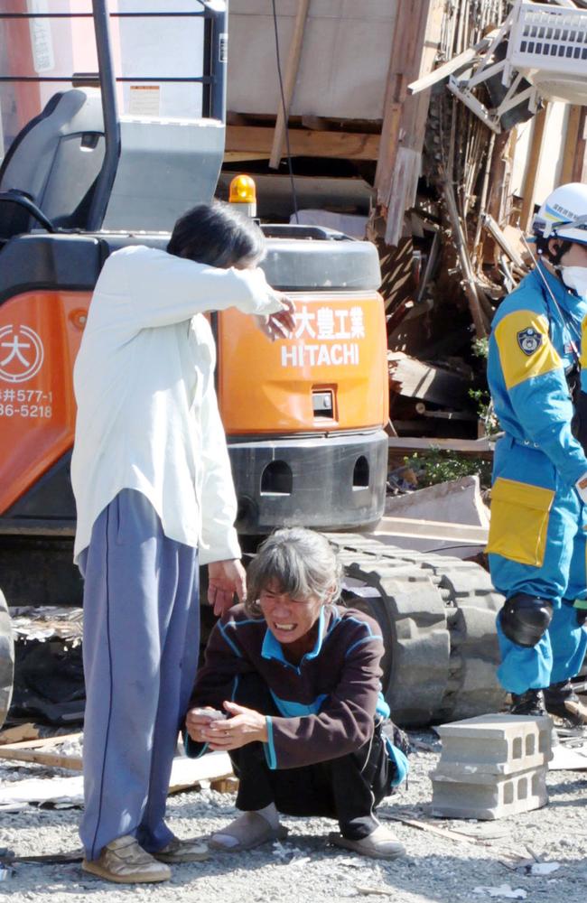 Parents cry as they confirm that their daughter was found dead after an earthquake in Mashiki, Kumamoto prefecture. Picture: Ryota Tajiri/Kyodo News.