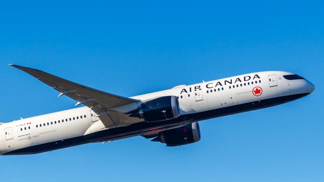 An Air Canada plane in the sky.