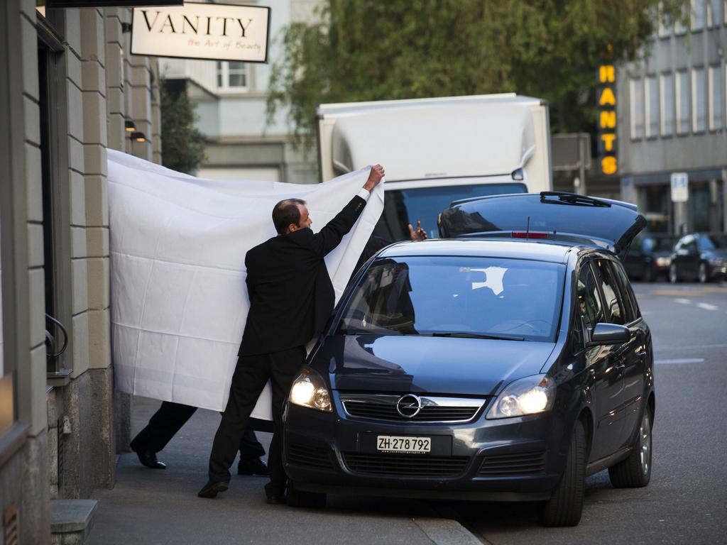 FIFA officials were escorted out behind sheets at the Baur au Lac hotel in Zurich.