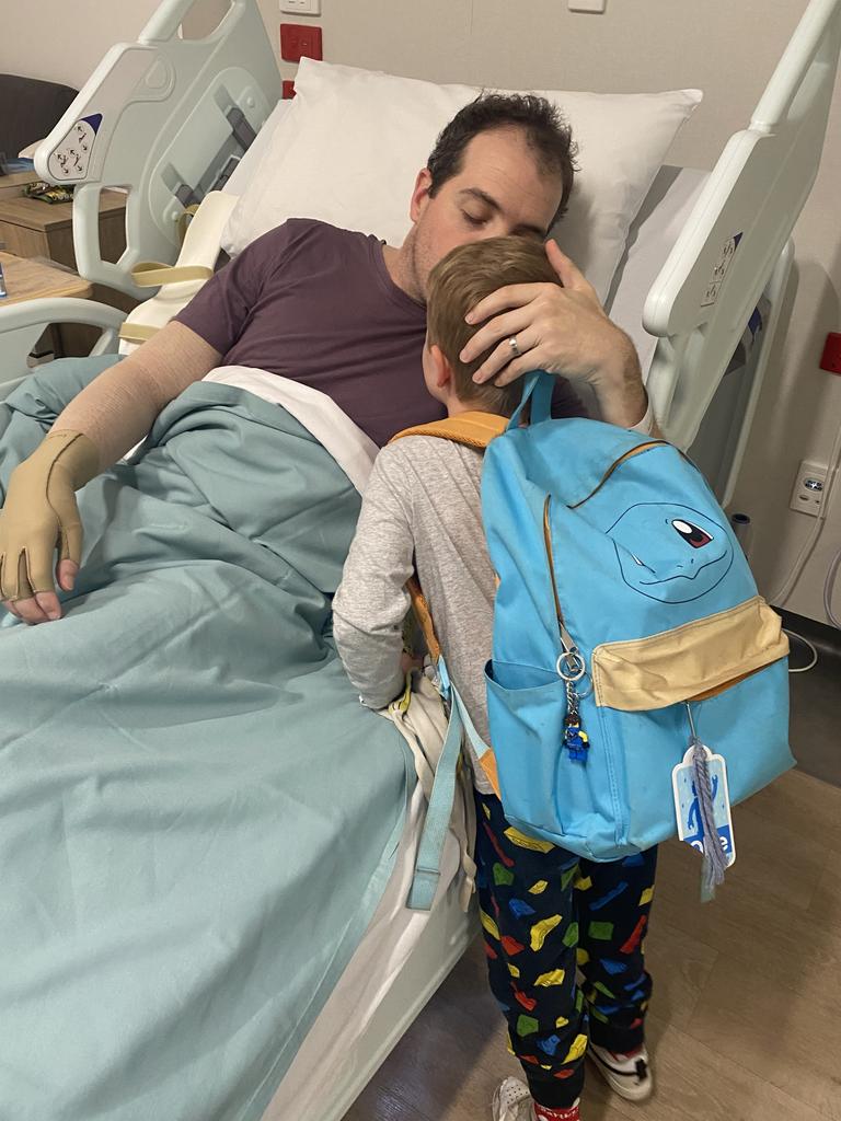 Ben with his son Oliver, then aged 5, while recovering in hospital. Picture: Tania Hyde