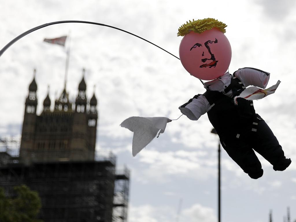 An activist holds aloft a puppet depicting Britain's Prime Minister Boris Johnson near parliament in London. Picture: Tolga AKMEN / AFP.