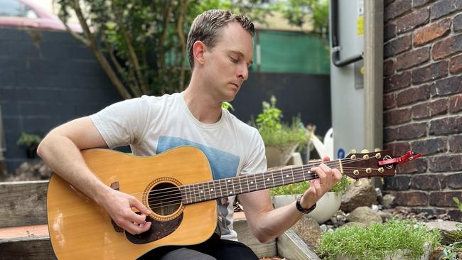 Andrew McMillen, The Australian's national music writer, at home in Brisbane with the acoustic guitar he received for his 16th birthday. Picture: Rachael McMillen