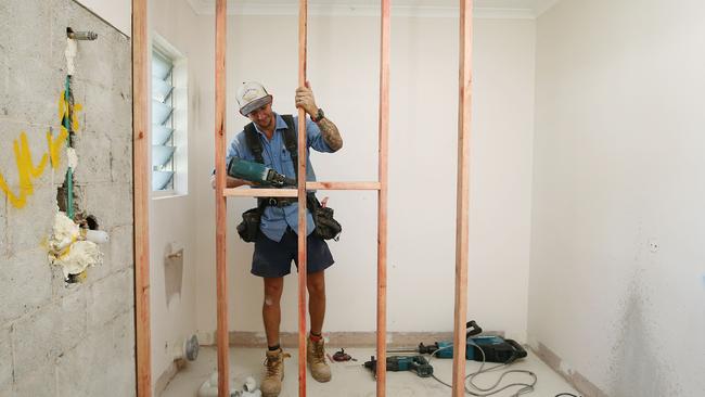 While tourism numbers in Cairns have been down since the COVID-19 coronavirus pandemic began, the housing and building construction trade has been booming. Maxa Construction carpenter Dan Davie installs an internal wall at a home renovation at Whitfield. Picture: Brendan Radke