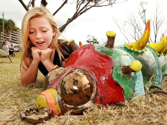 Swell Sculpture Festival: Jordyn Hamilton 10 looking at work by Monte Lupo called Attenboroughs Minions. Picture: Mike Batterham